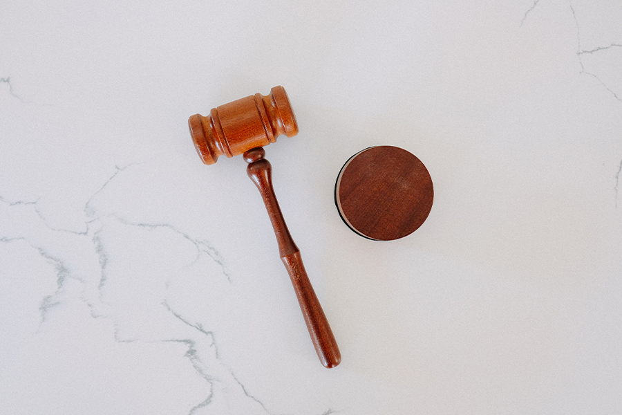 wooden gavel on a white marble backdrop